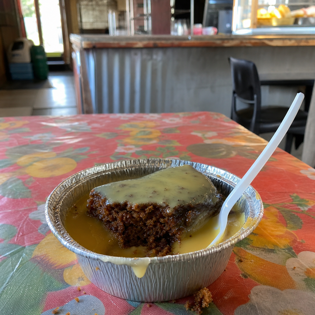 Malva pudding and custard in a takeaway bowl